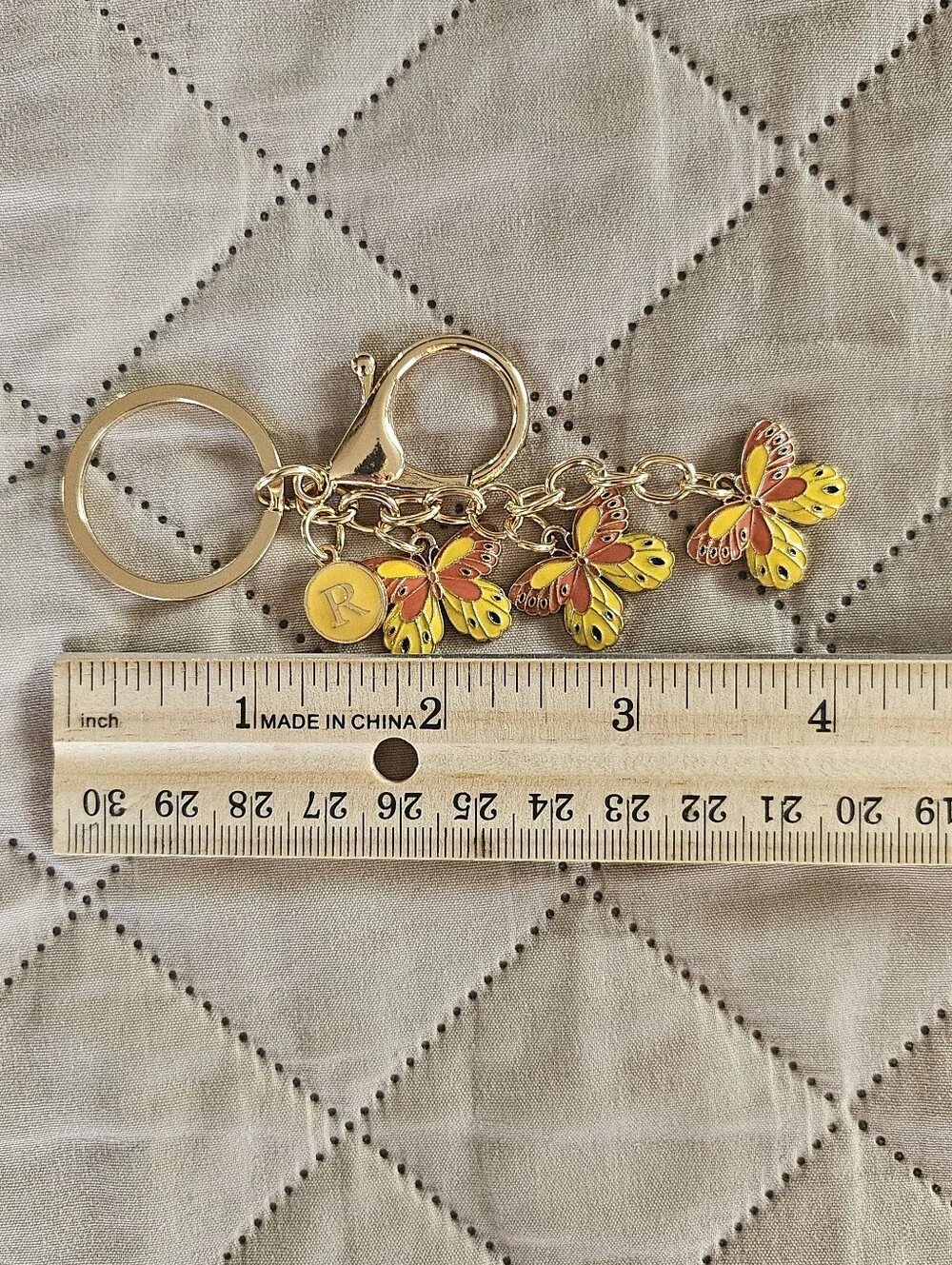 Yellow butterfly keyring, keychain. Bag charm. Has an R charm but can be removed